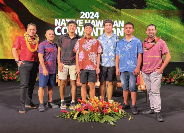 Kumu Kaipo Leopoldino and several students from the Kalamakū Academy, are pictured here with Kuhio Lewis, President and CEO of the Office of Native Hawaiian Advancement.